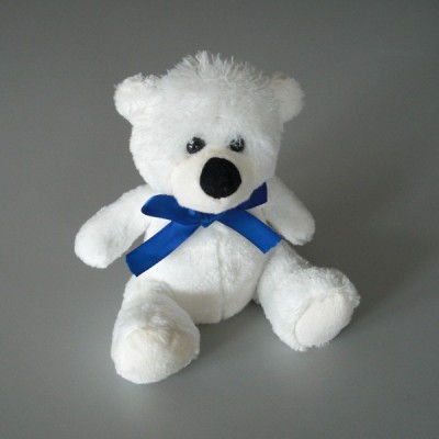 Peluche ourson assis avec noeud